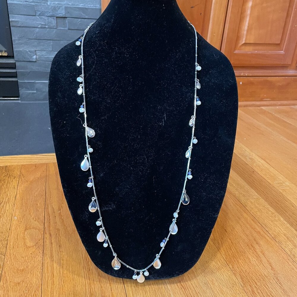 Long silver necklace with semi-precious pearls and stones.